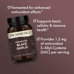 Dr. Mercola Fermented Black Garlic bottle being poured to dispense a capsule