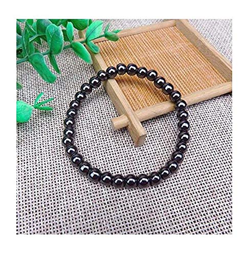Dr Kao smooth beads on wrist emphasize understated luxury with light-catching gloss.