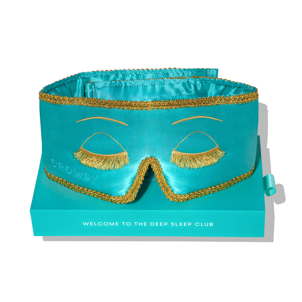 Drowsy silk sleep mask in turquoise with gold embroidery for elegant bedtime.