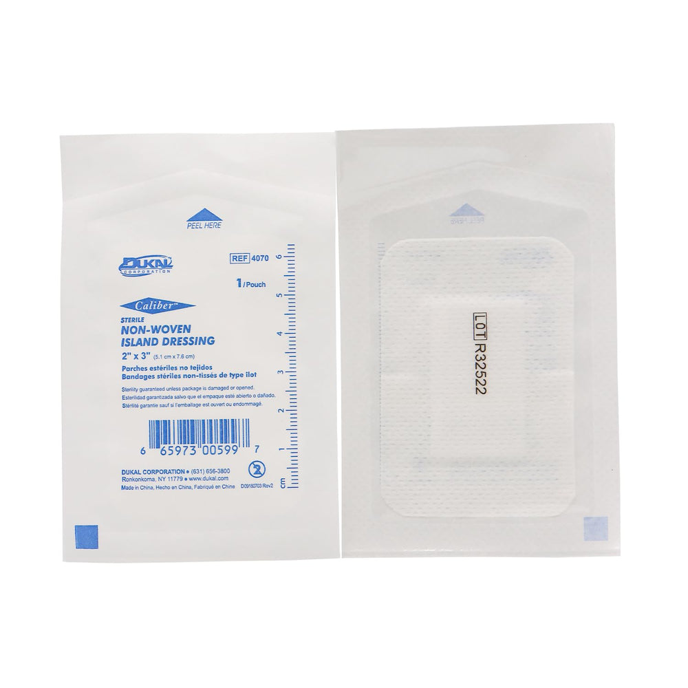 Dukal white nonwoven island dressing 2x3 laid flat beside packaging for easy application
