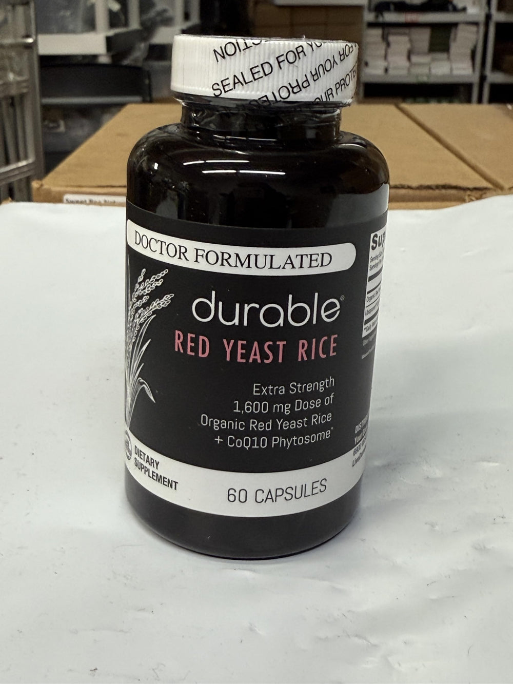 Durable RED Yeast Rice capsules on white background for daily routine.