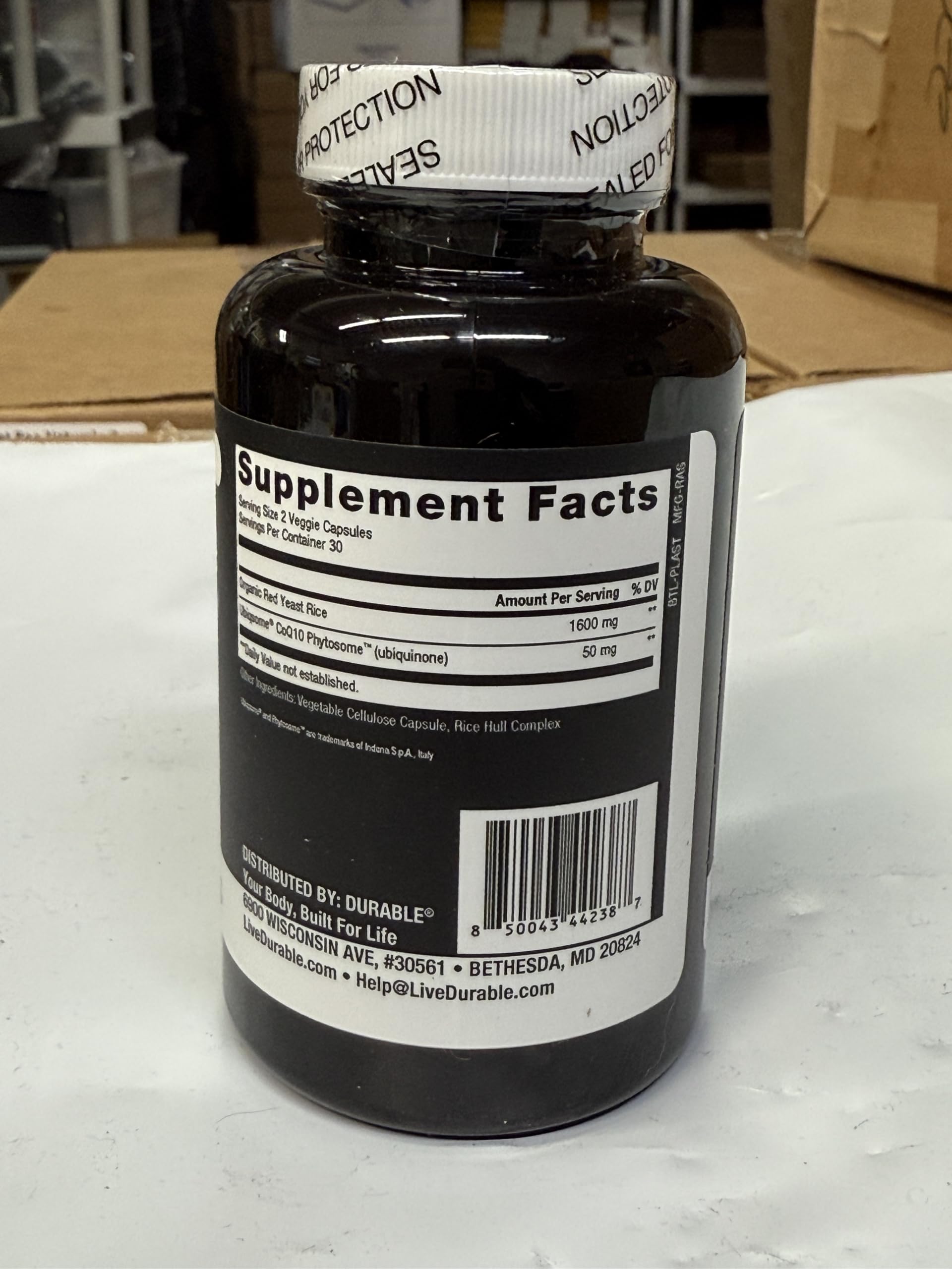 Durable RED Yeast Rice label close-up showing dosage information for daily use.