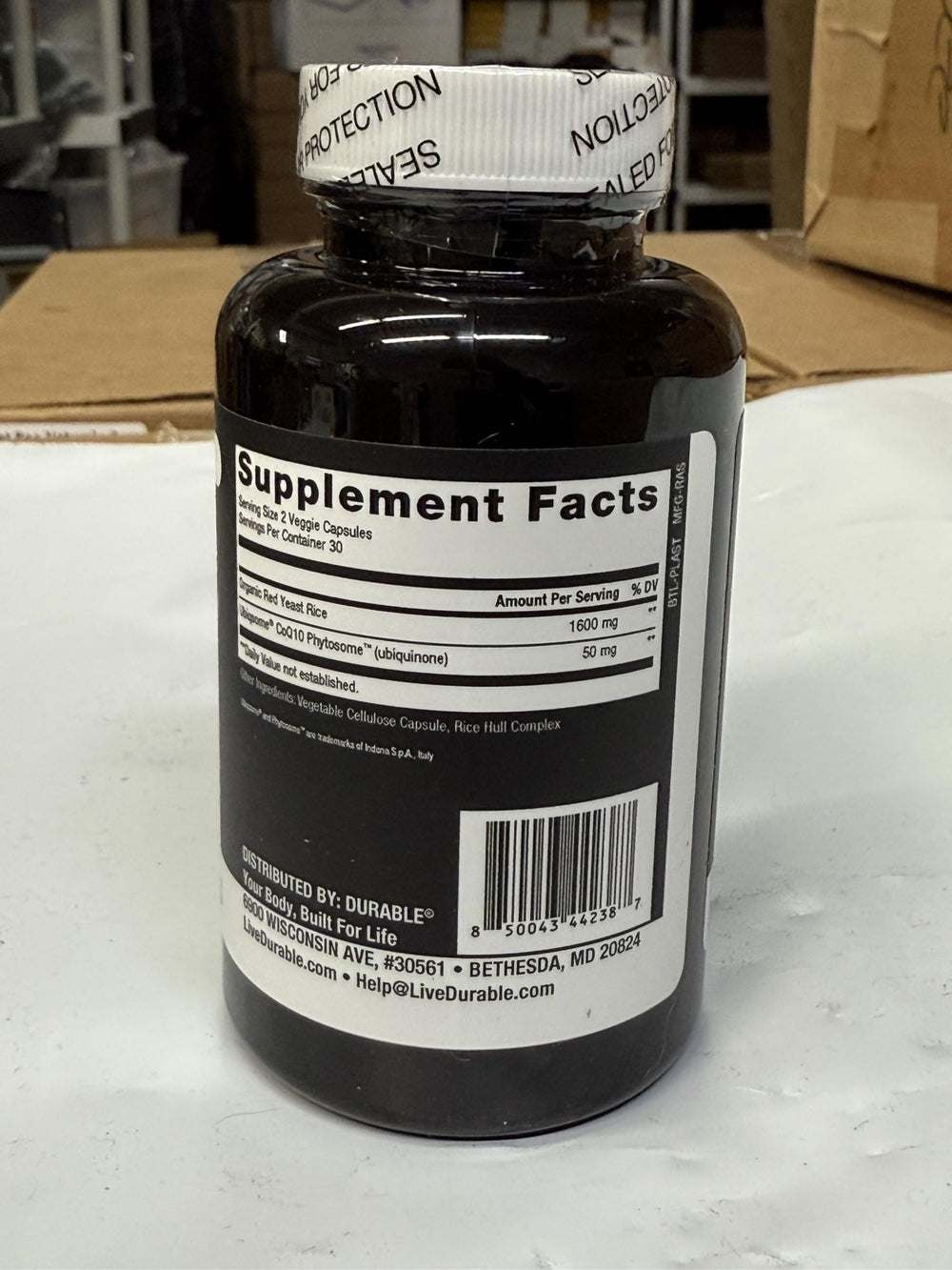 Durable RED Yeast Rice label close-up showing dosage information for daily use.