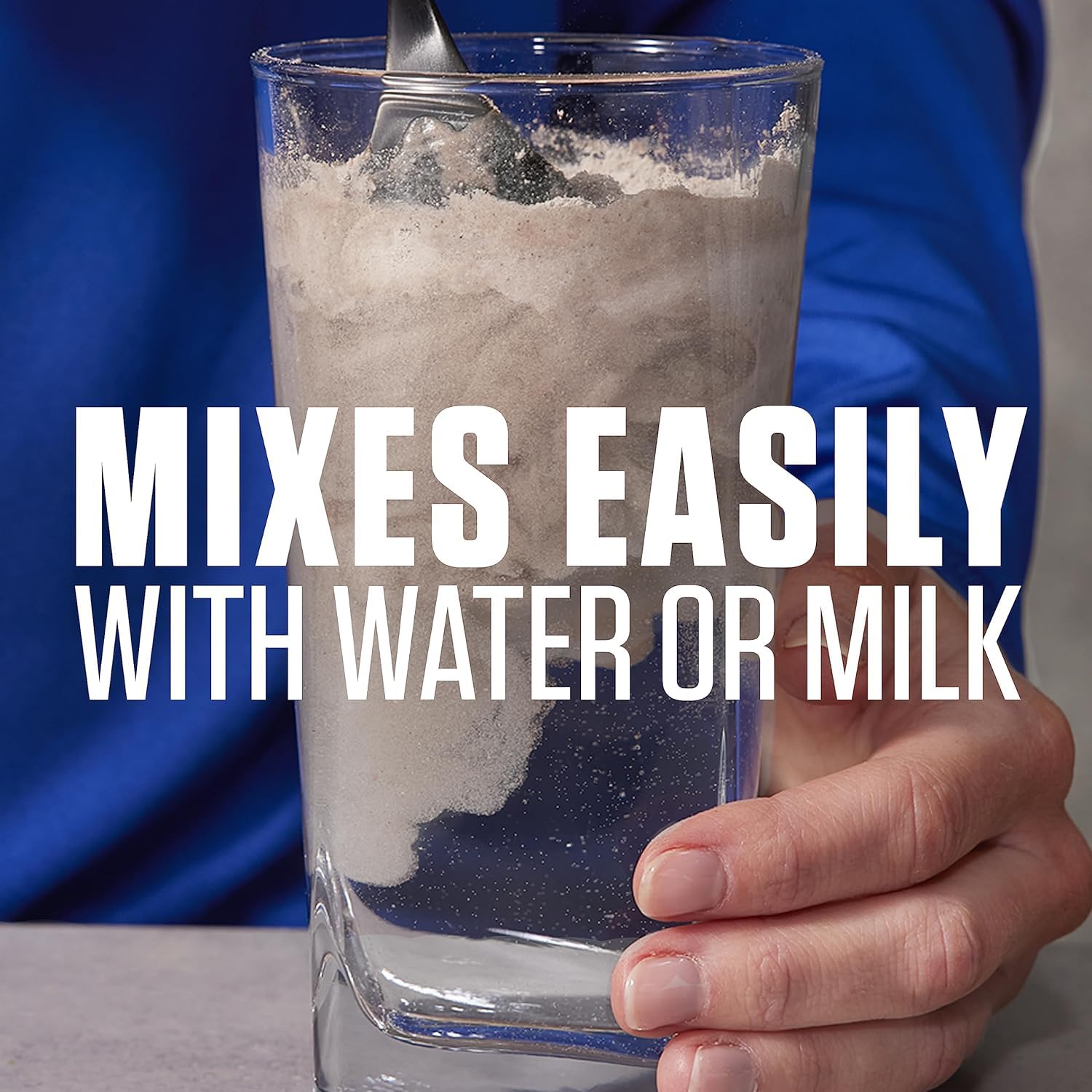 Dymatize Elite Whey Vanilla being poured into shaker for quick mix