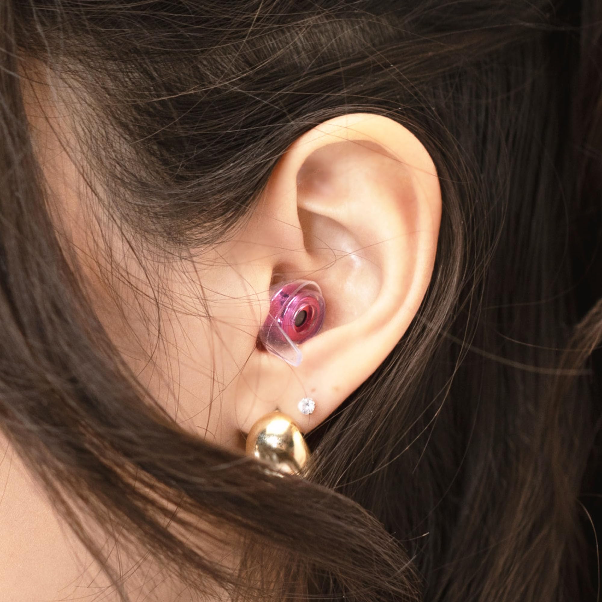 Worn at a live concert, Eargasm earplugs preserve music clarity while reducing loudness.