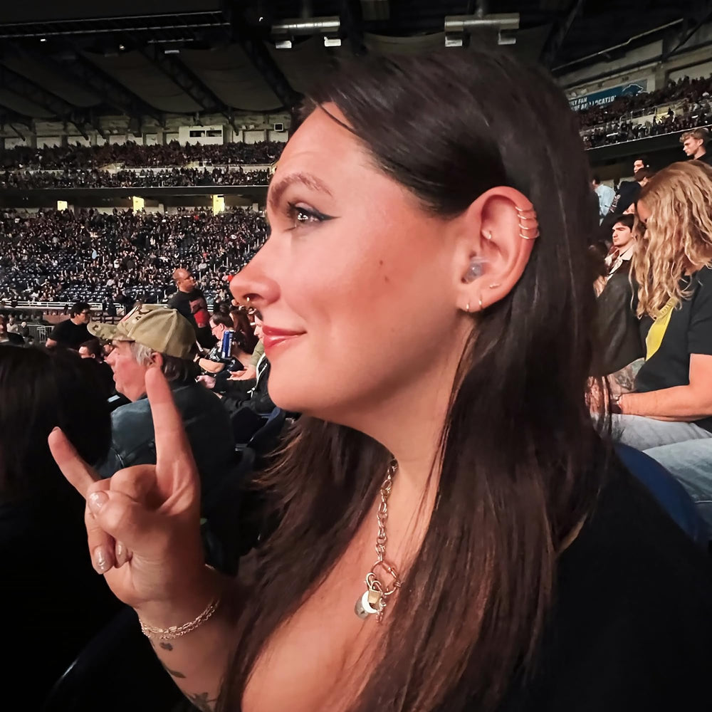 Live music scene with Eargasm earplugs offering clarity while reducing volume.