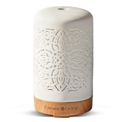 Earnest Living white ceramic diffuser emitting a soft mist for a calm space.
