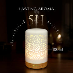 Earnest Living diffuser on a wooden desk with warm ambient light.