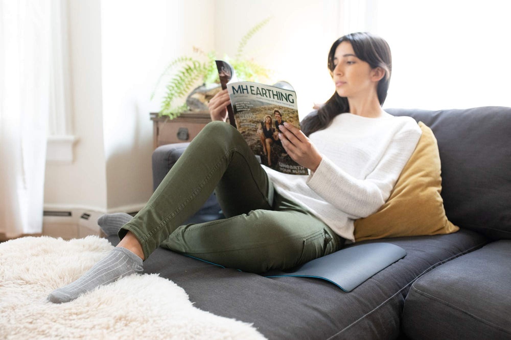 Earthing Universal Mat Kit placed in living room for relaxing grounding at home.