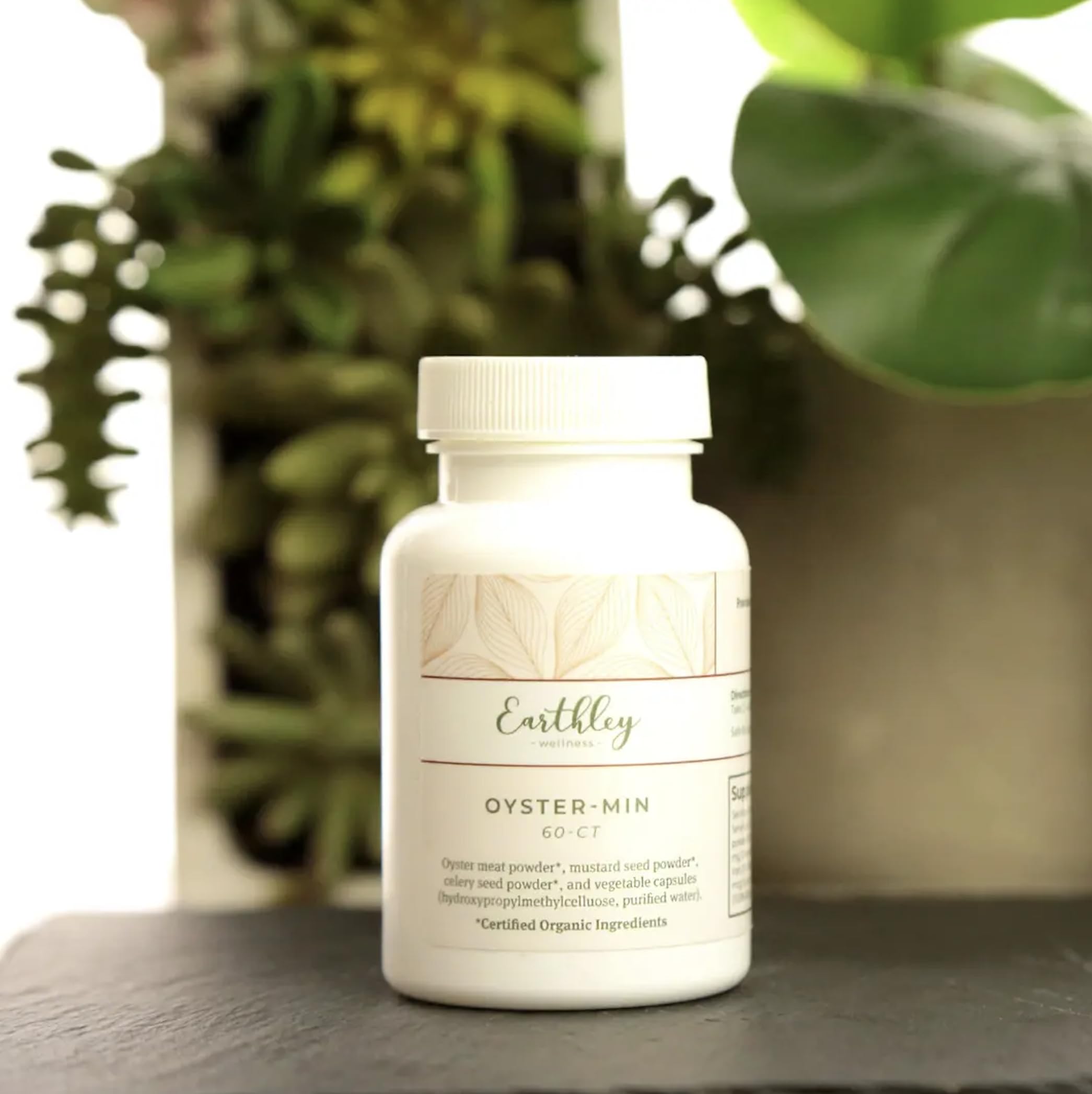 Earthley Oyster-Min capsules being poured from bottle for easy daily use