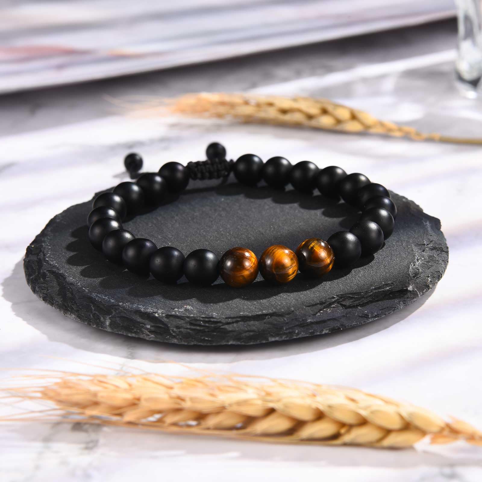 EFVISD healing bracelet close-up shows black agate and tiger eye beads.