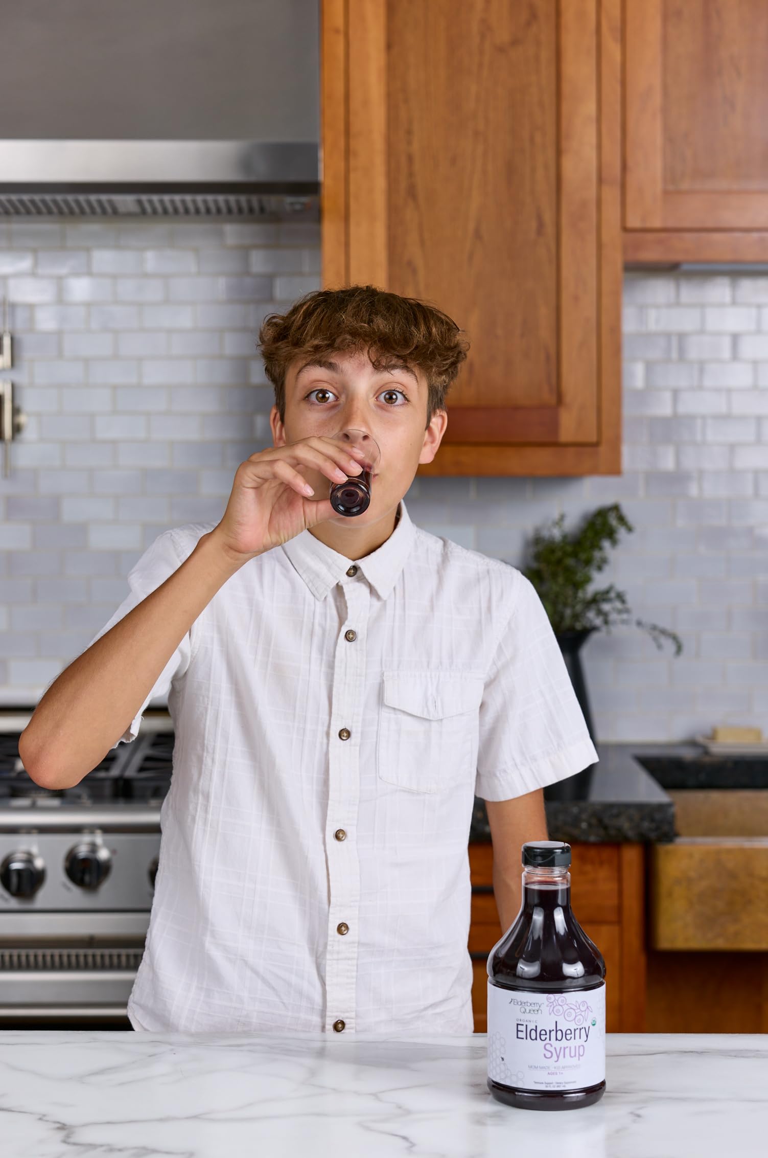 Elderberry Queen bottle with spoon, easy to measure servings.