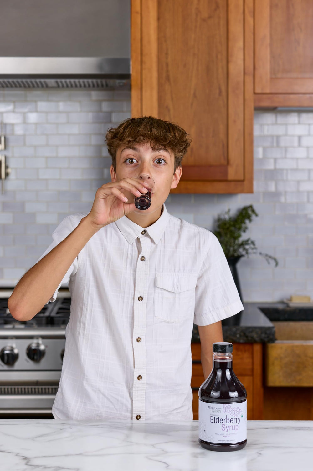Elderberry Queen bottle with spoon, easy to measure servings.