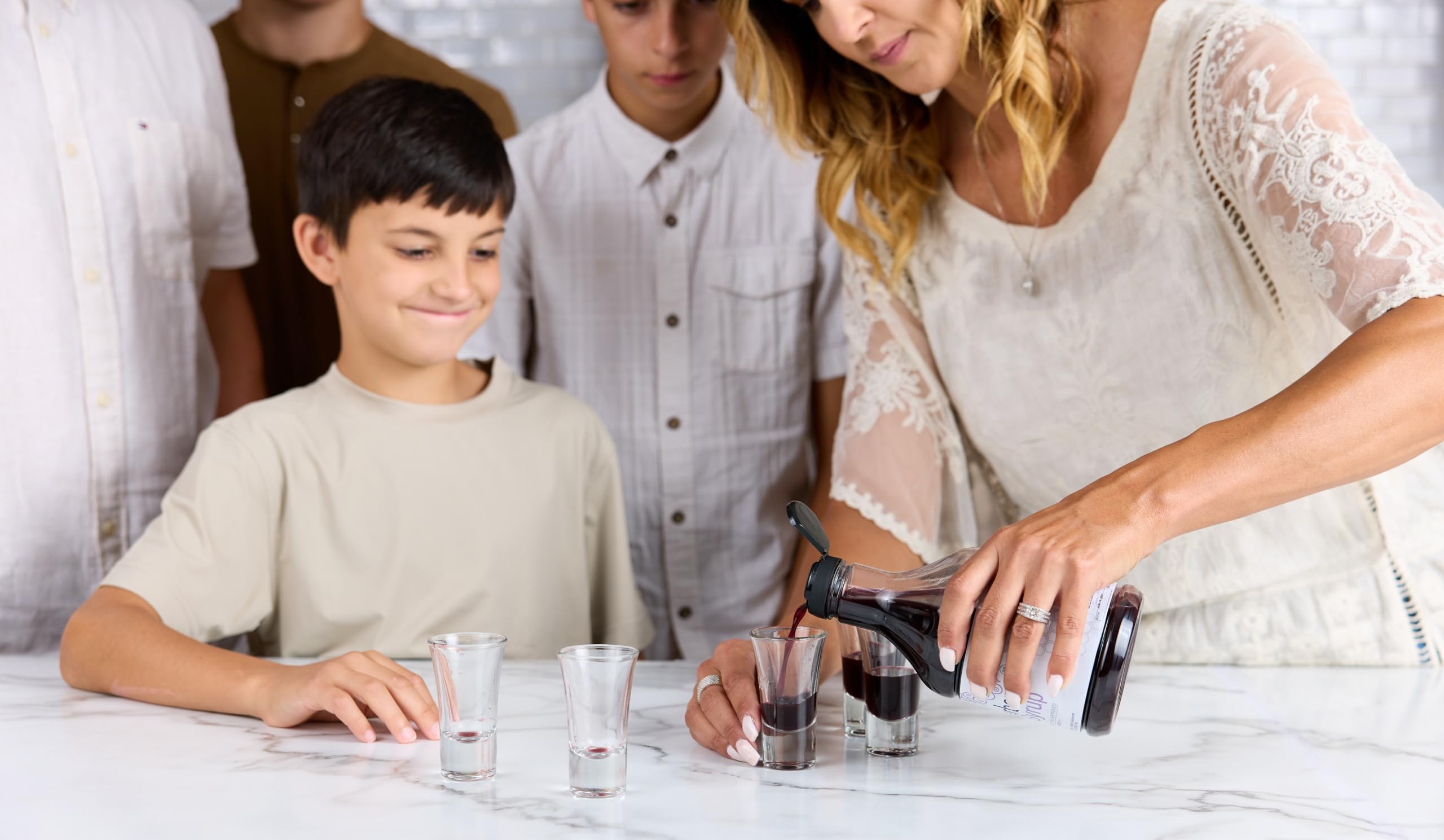 Elderberry Queen family-use bottle with glass, ideal for shared routines.