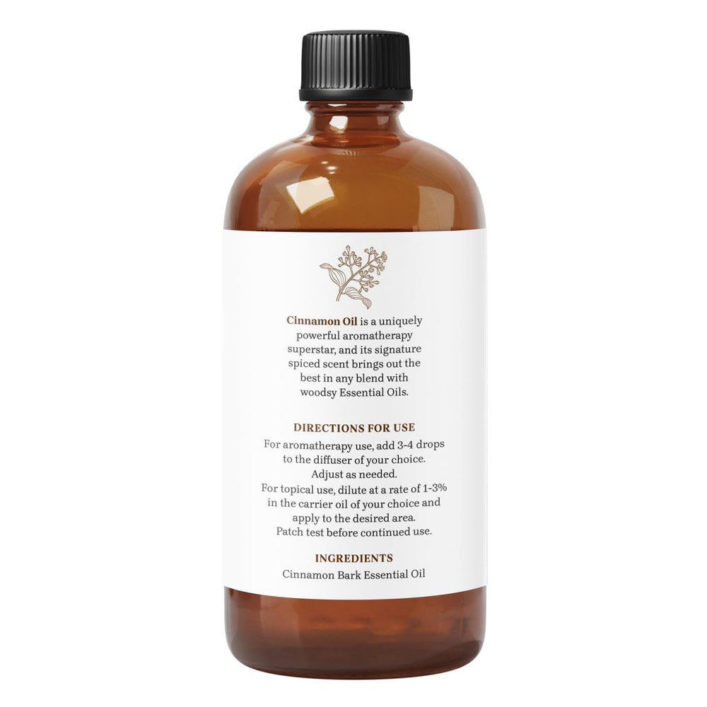 Essential Delights cinnamon essential oil bottle beside diffuser for home fragrance