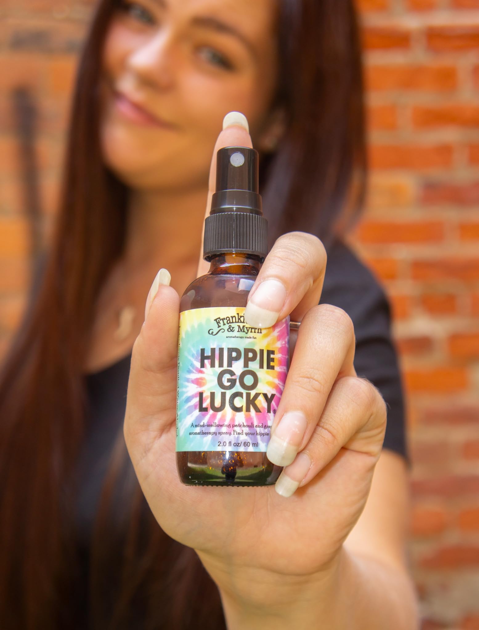 Frankie and Myrrh Hippie Go Lucky spray mist in hand ready to refresh spaces