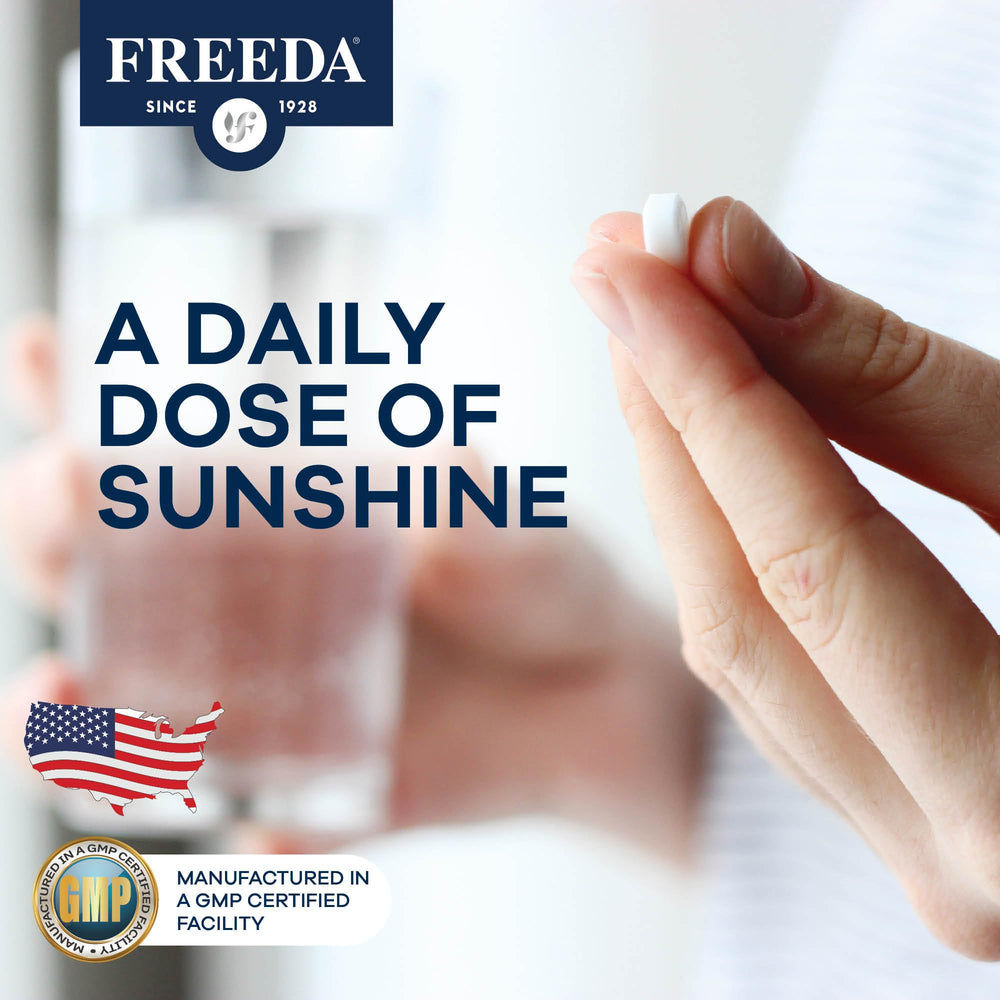 Hand holding FREEDA D3 tablets for everyday supplementation.