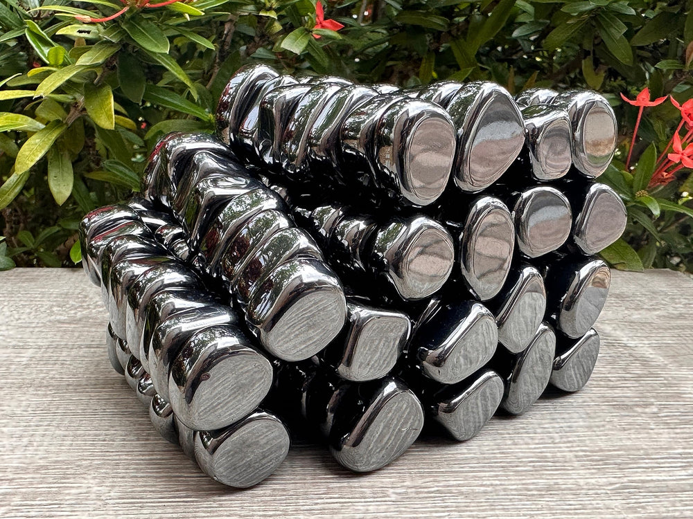 GAF TREASURES hematite stones in hand for pocket carry balance.