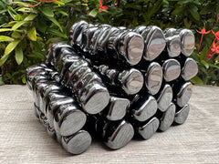 GAF TREASURES hematite stones in hand for pocket carry balance.