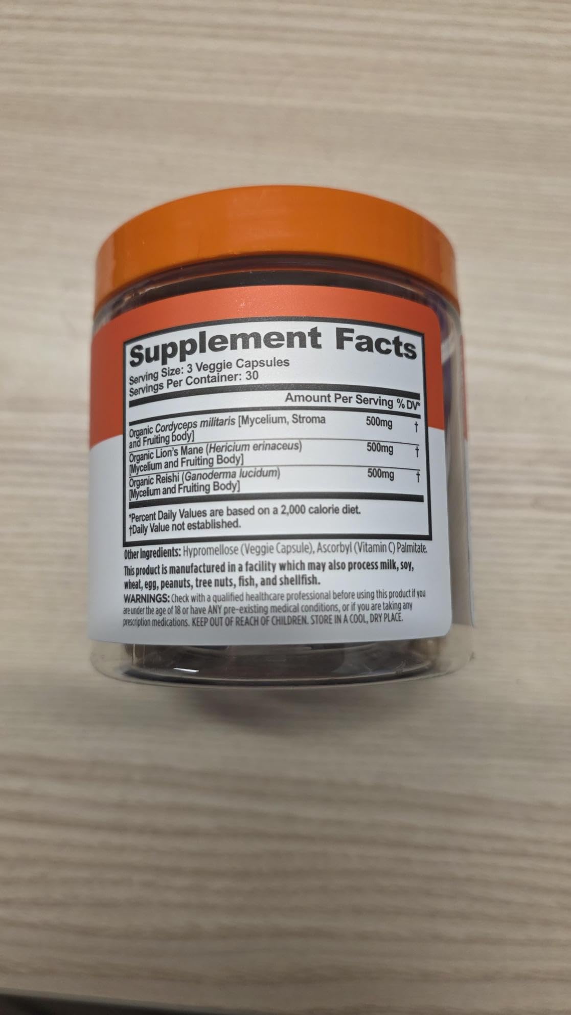 Genius Mushrooms capsules pictured as part of a plant-based wellness routine.