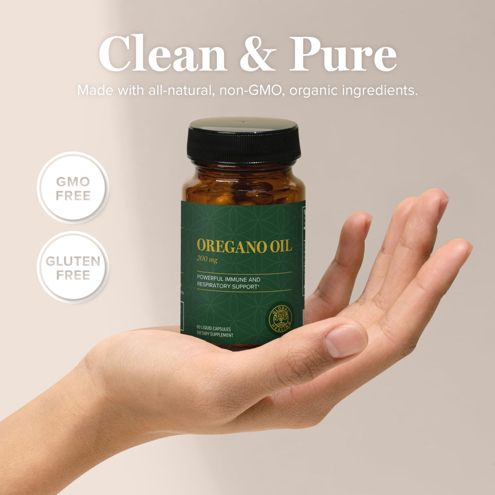 Global Healing Center oregano oil capsules in hand for on-the-go wellness.