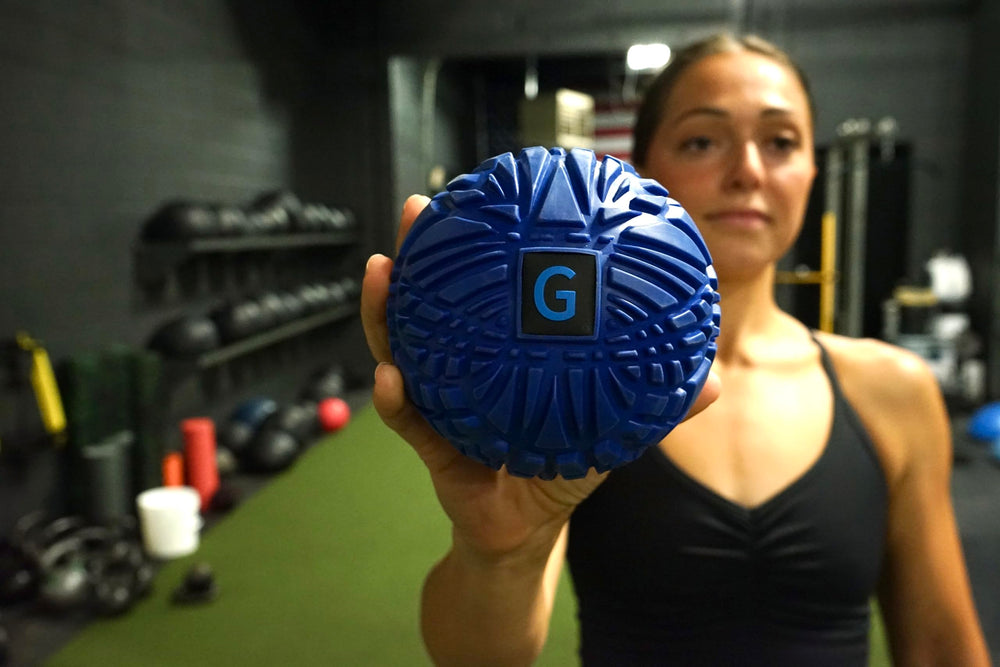 GolgiStim Large Trigger Point Ball targeting knots in arms or legs for relaxation.