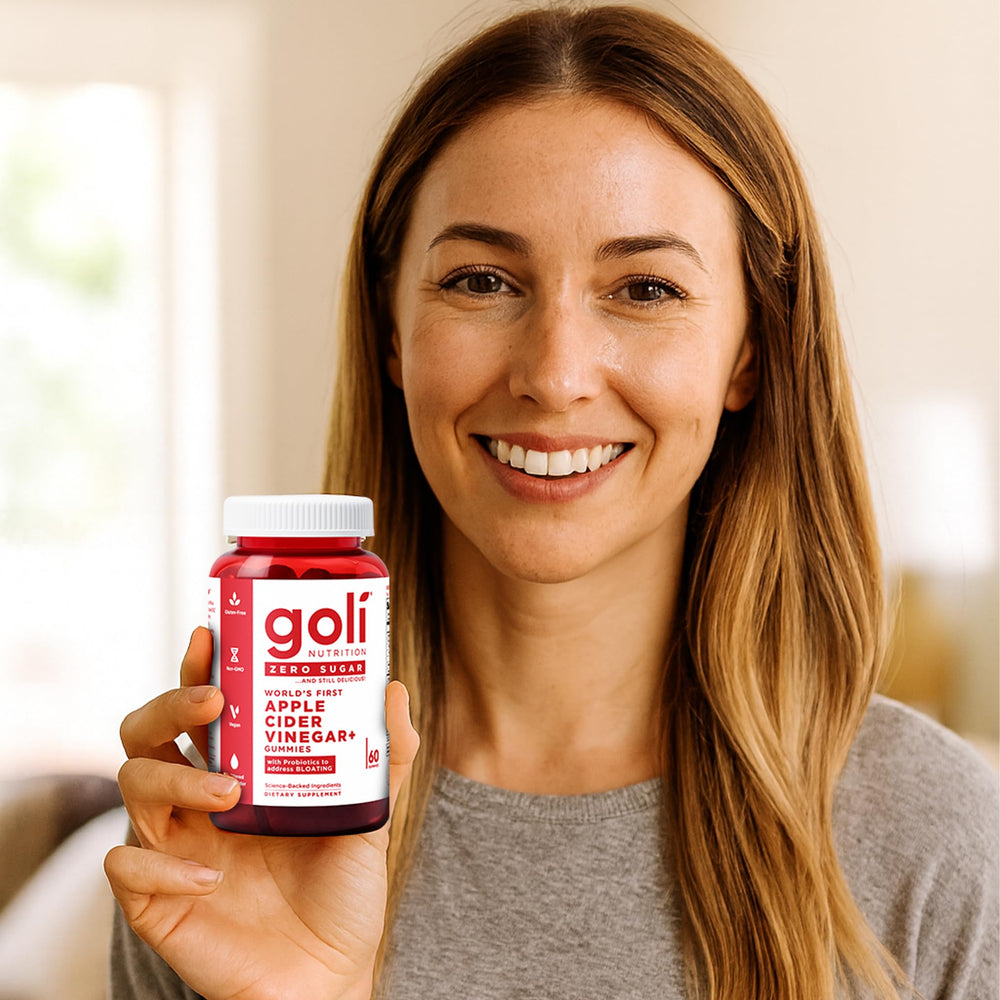 Goli daily-use gummies in hand for morning routine.