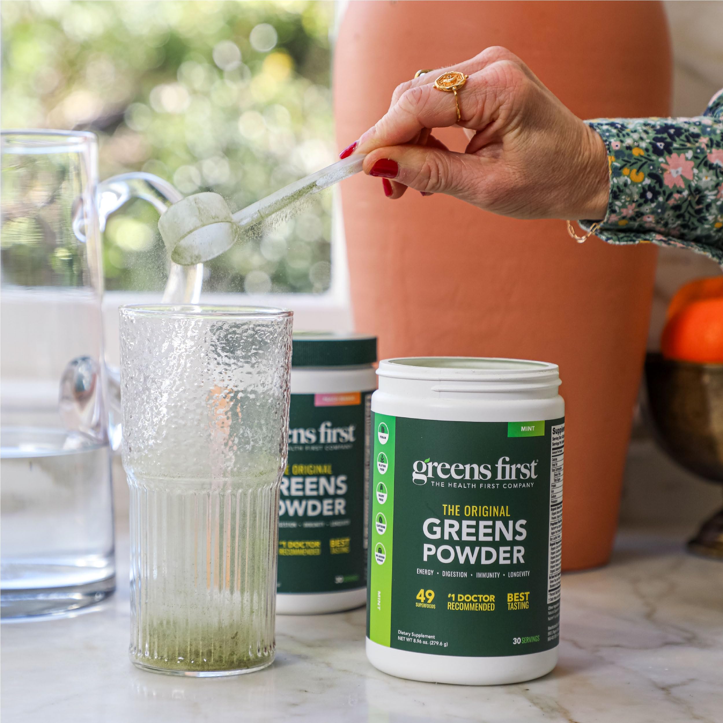 Greens First smoothie in a glass with chocolate flavor.