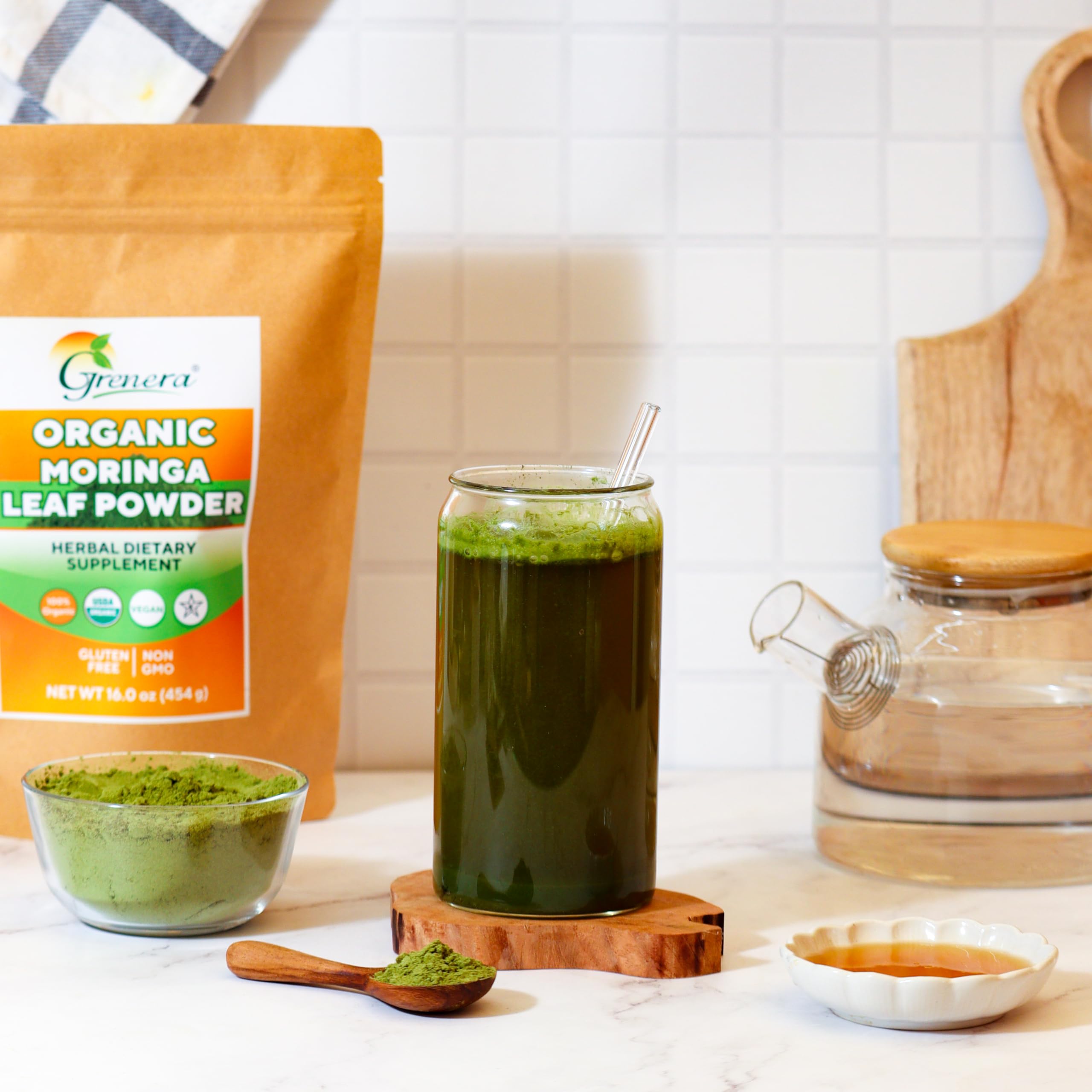 Grenera Moringa powder scoop in glass; easy daily mix for shakes and tea.