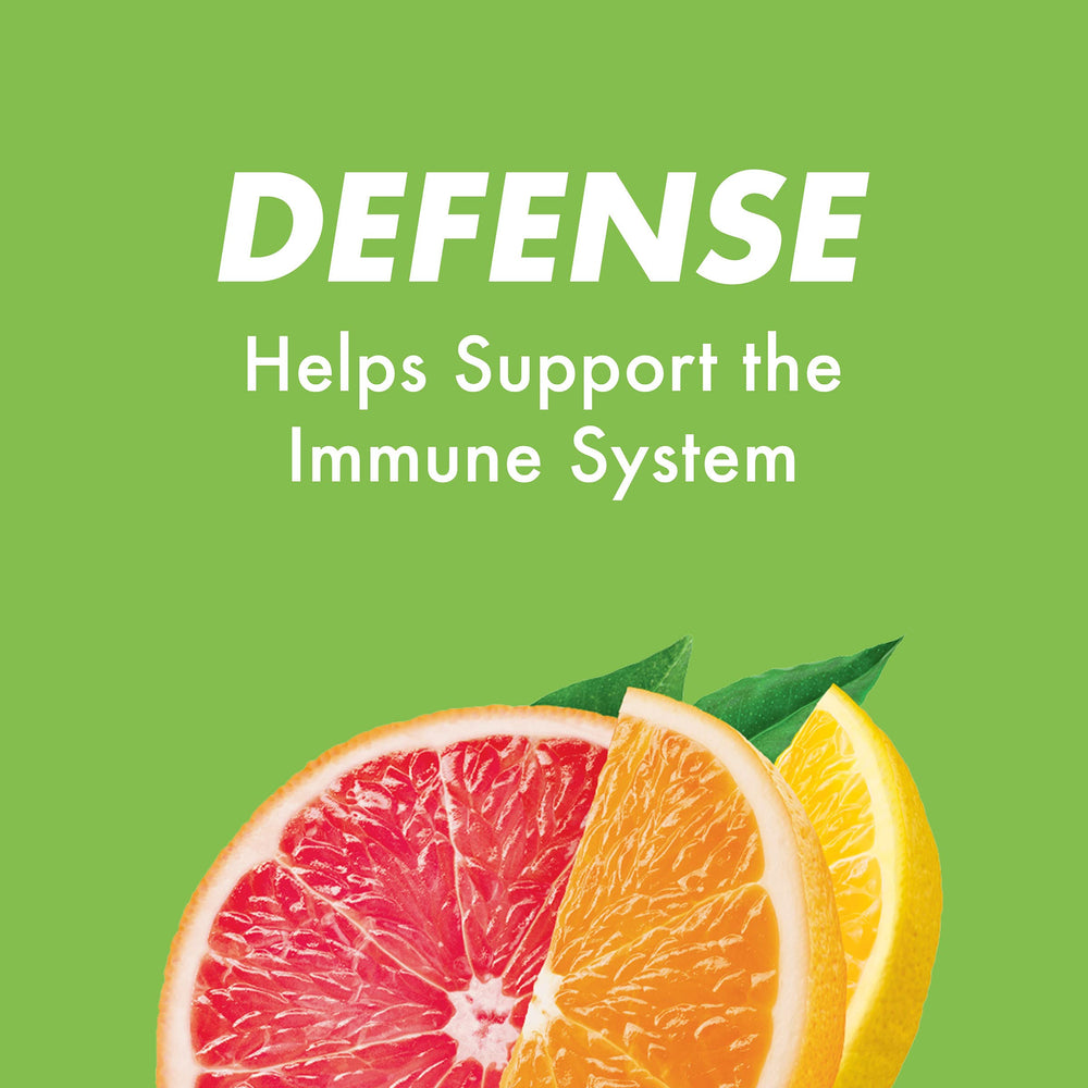 HALLS Defense drops in hand showing portable vitamin C on the go