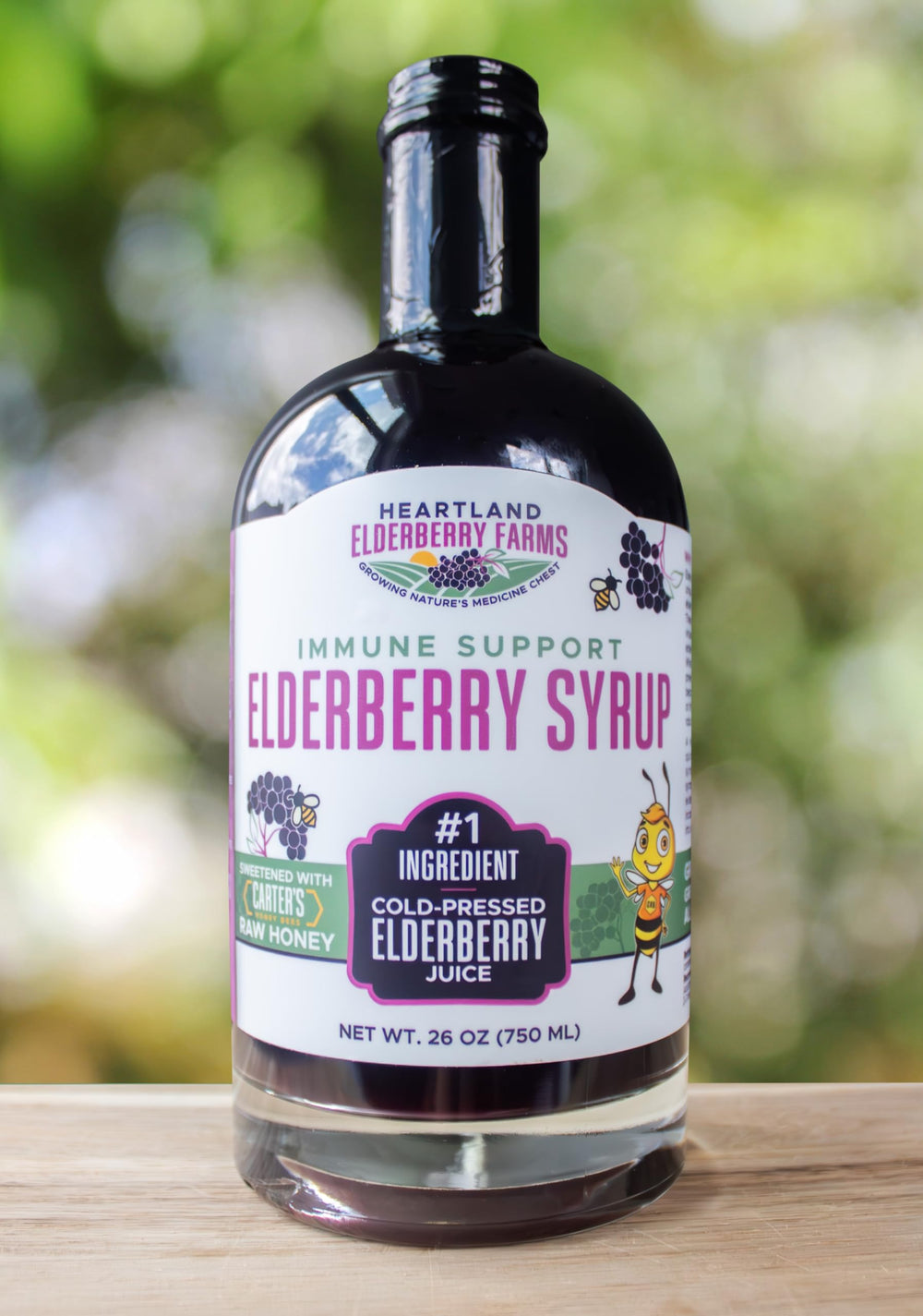 Heartland Organic Elderberry Syrup bottle pour demonstrates easy daily use.