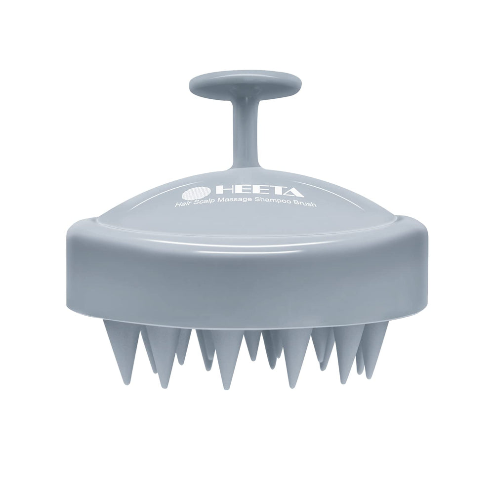 HEETA scalp massager with soft silicone bristles for gentle exfoliation and relaxation.