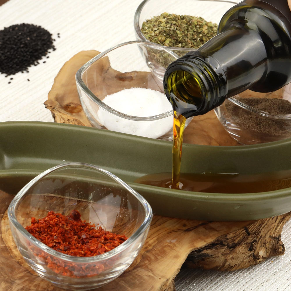 Measuring spoon with Herbal Wind Black Seed Oil for precise dosing.
