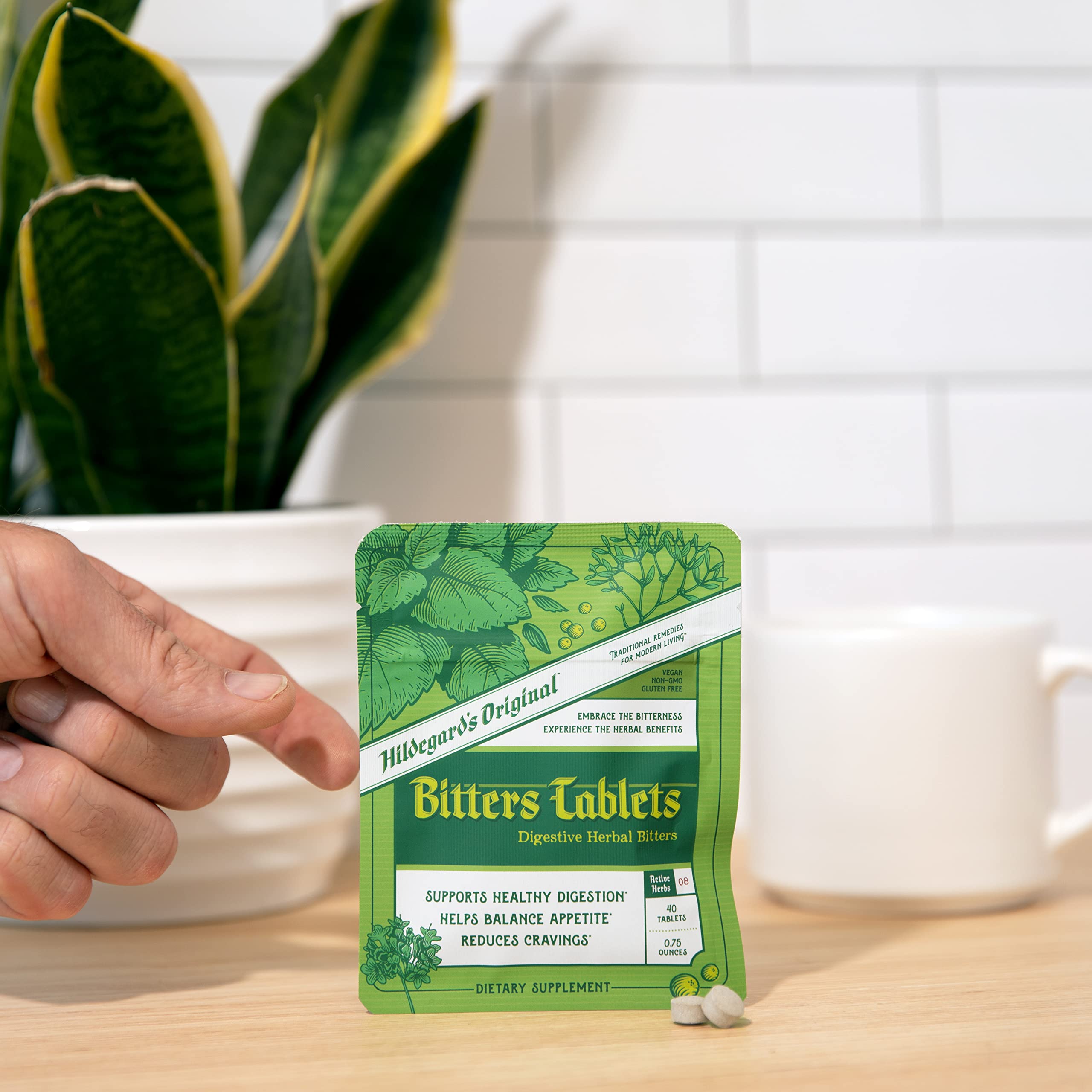 Hildegard's Original Bitters cardamom seed imagery signals bright notes and digestive support