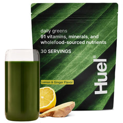 Huel Daily Greens powder scoop showing vibrant lemon-ginger blend for daily nutrient boost
