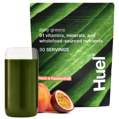 Huel Daily Greens Peach Passionfruit bottle front shows convenient daily nutrition.