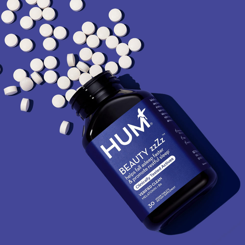 Hum Beauty zzZz bottle on nightstand evokes calm and ready-to-rest mood