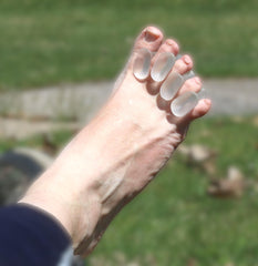 Iconikal gel toe spacers worn inside a shoe during daily activity for toe alignment.