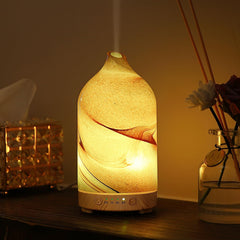 Inrorans diffuser with hand-blown glass brown rock pattern creates calming ambient lighting.