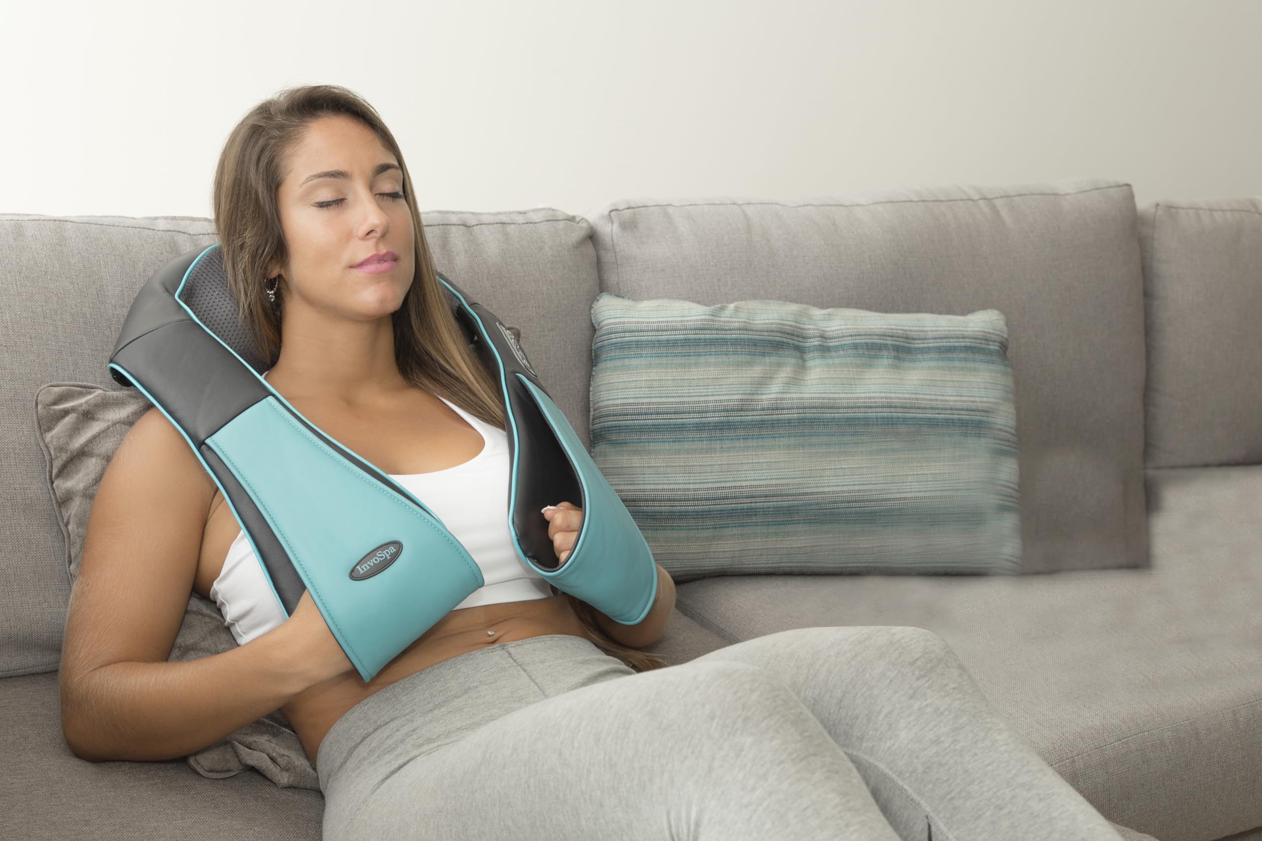 InvoSpa in-use on shoulders for upper back comfort.