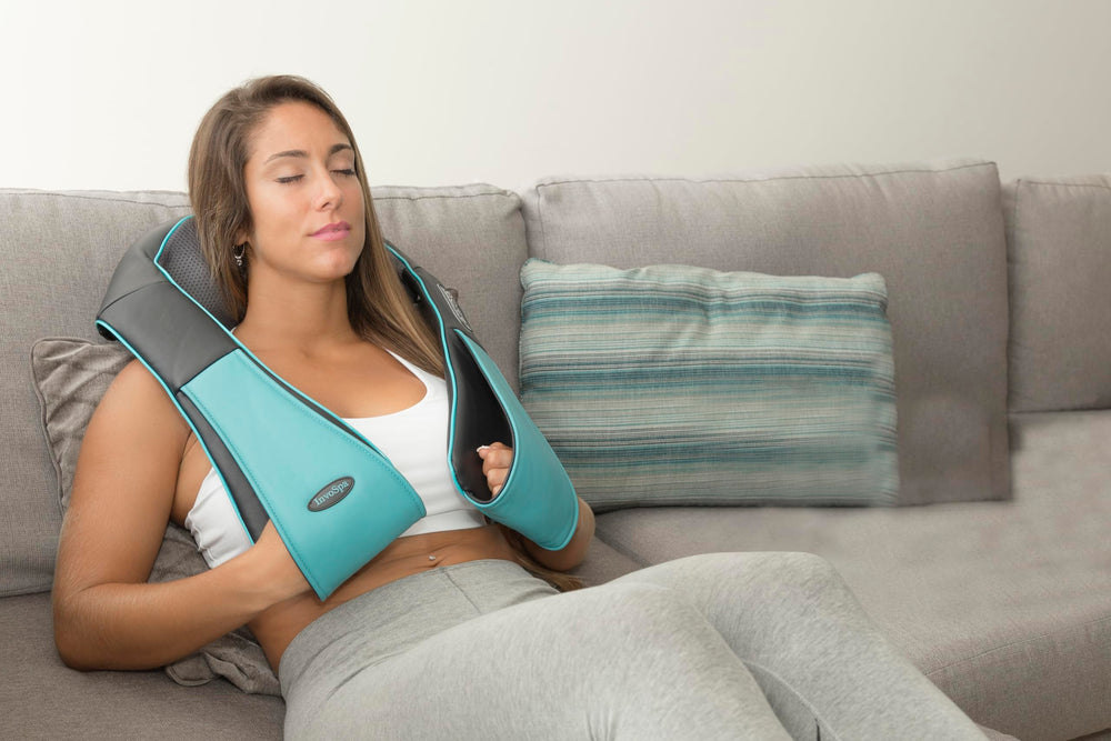 InvoSpa in-use on shoulders for upper back comfort.
