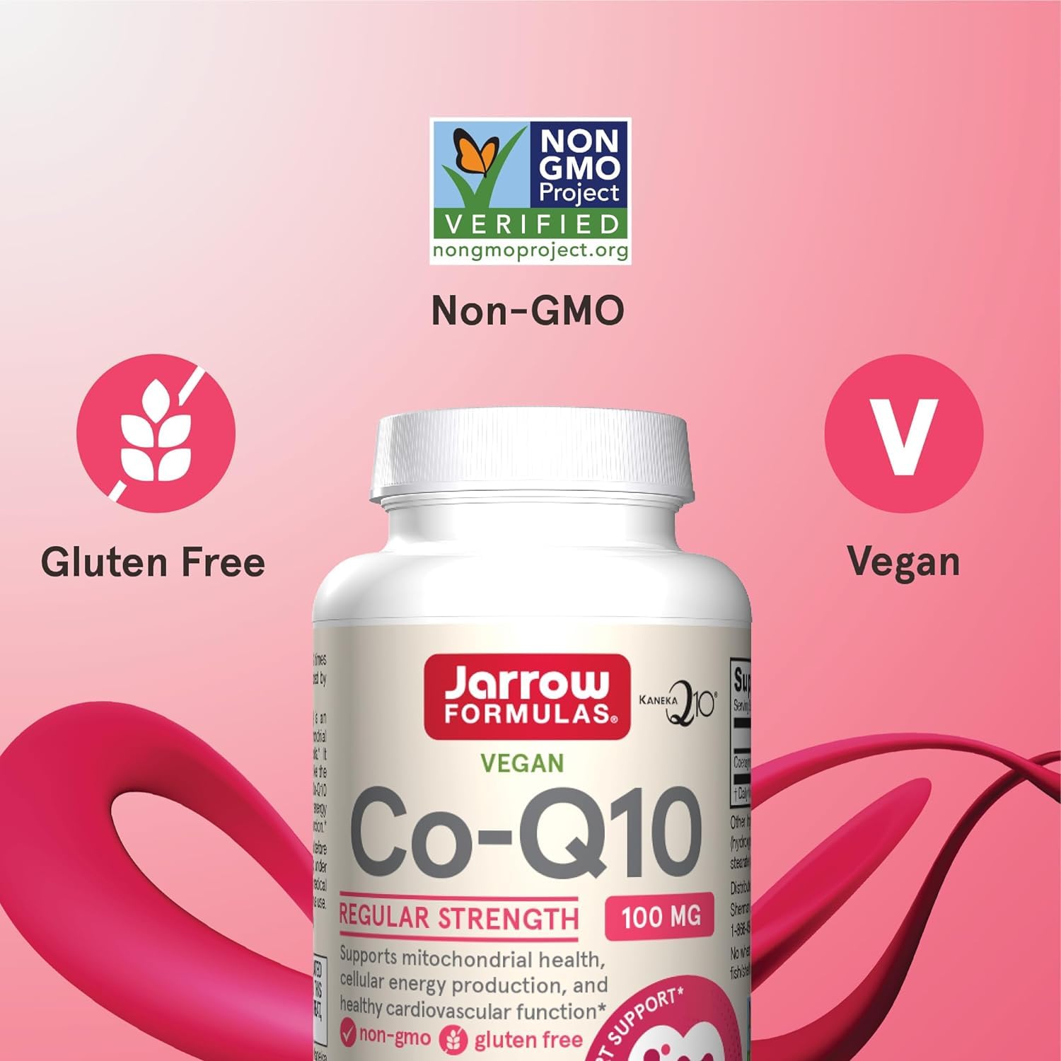 Hand holding Jarrow Formulas Co-Q10 bottle in a kitchen setting.