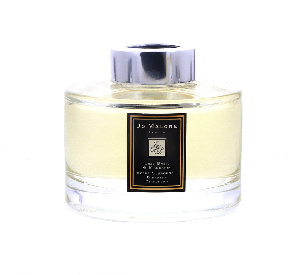Jo Malone diffuser reeds close-up releasing a fresh scent in a modern space.
