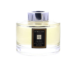 Jo Malone diffuser reeds close-up releasing a fresh scent in a modern space.