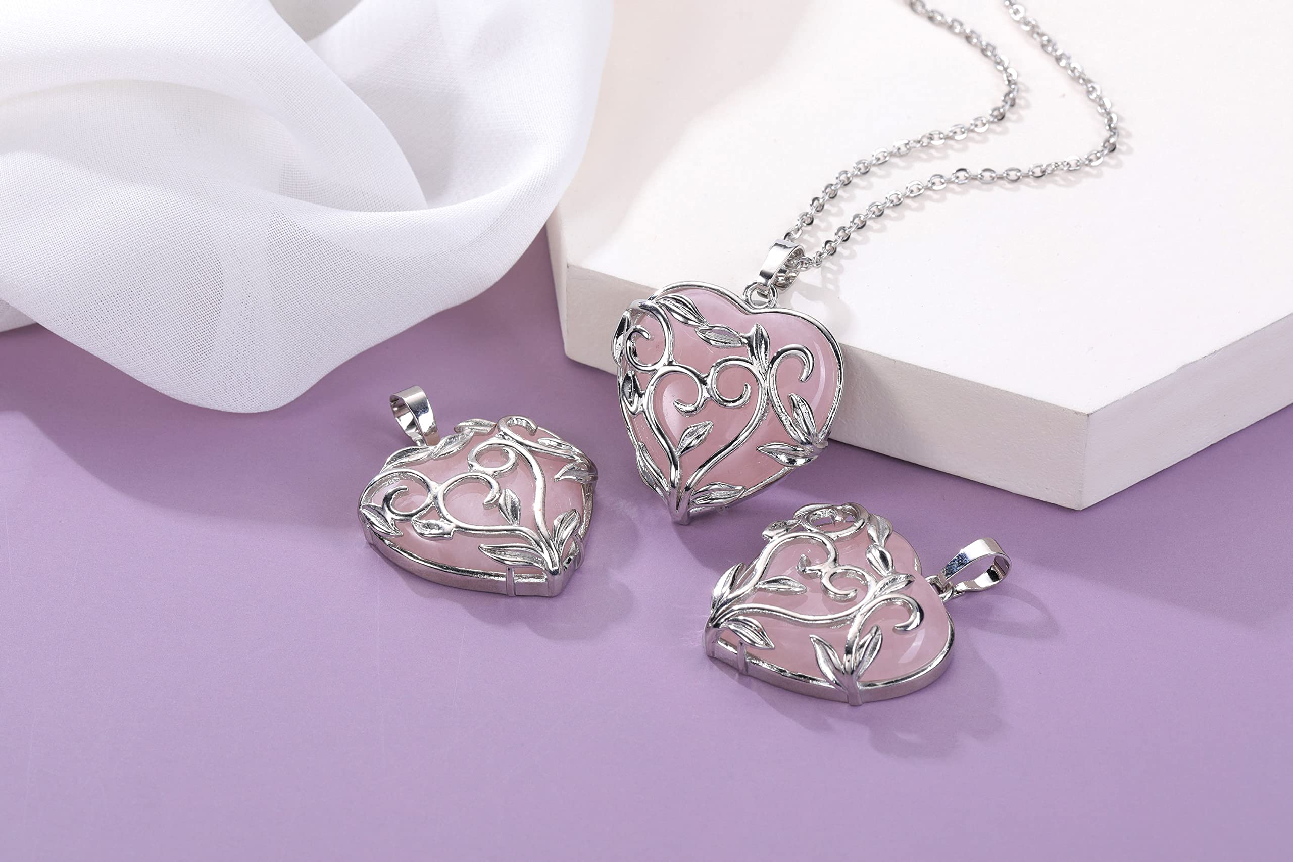 Jovivi rose quartz necklace close-up showing chain and stone.