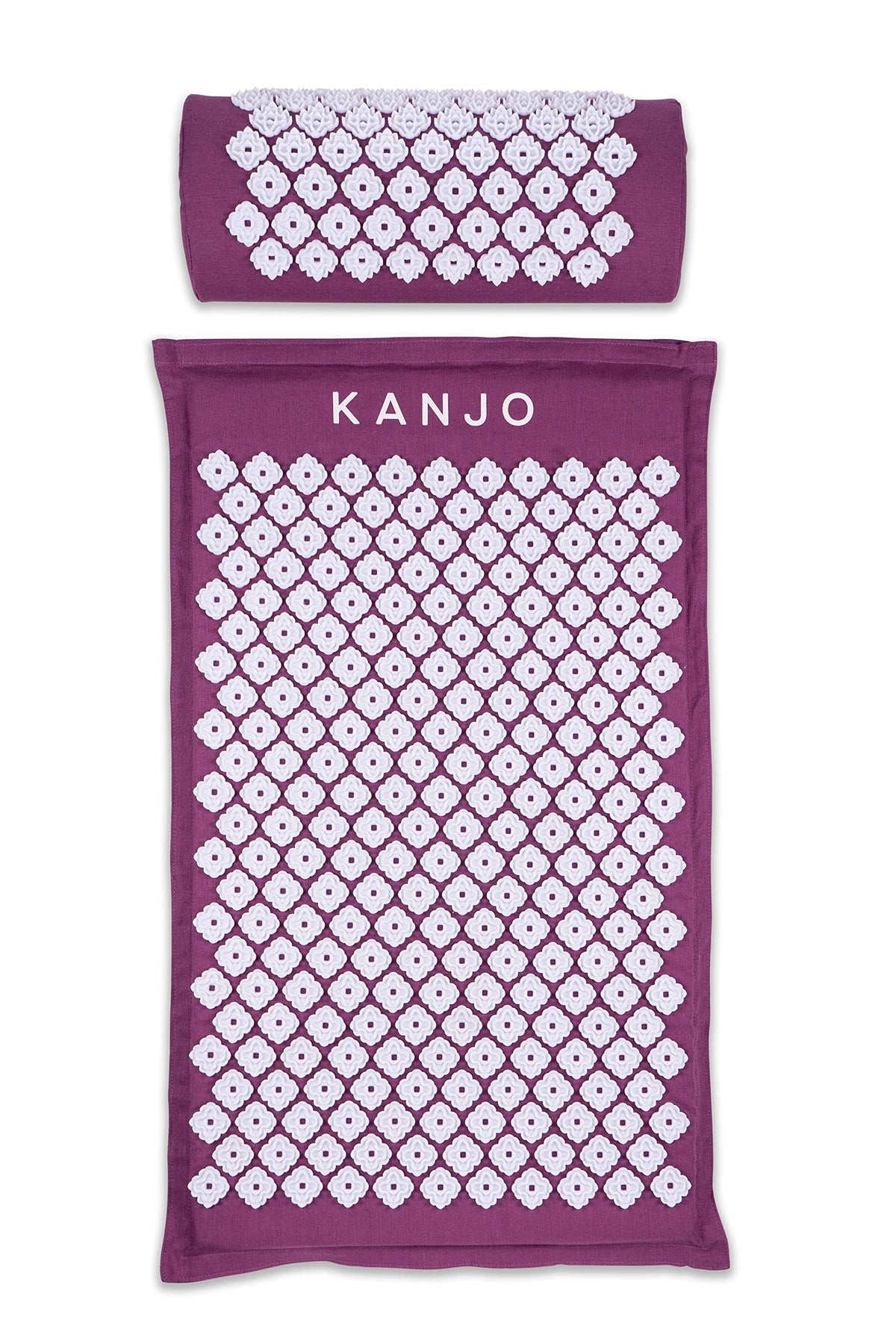 Kanjo acupressure mat in amethyst on bed, targeting back pressure points for relaxed muscles.