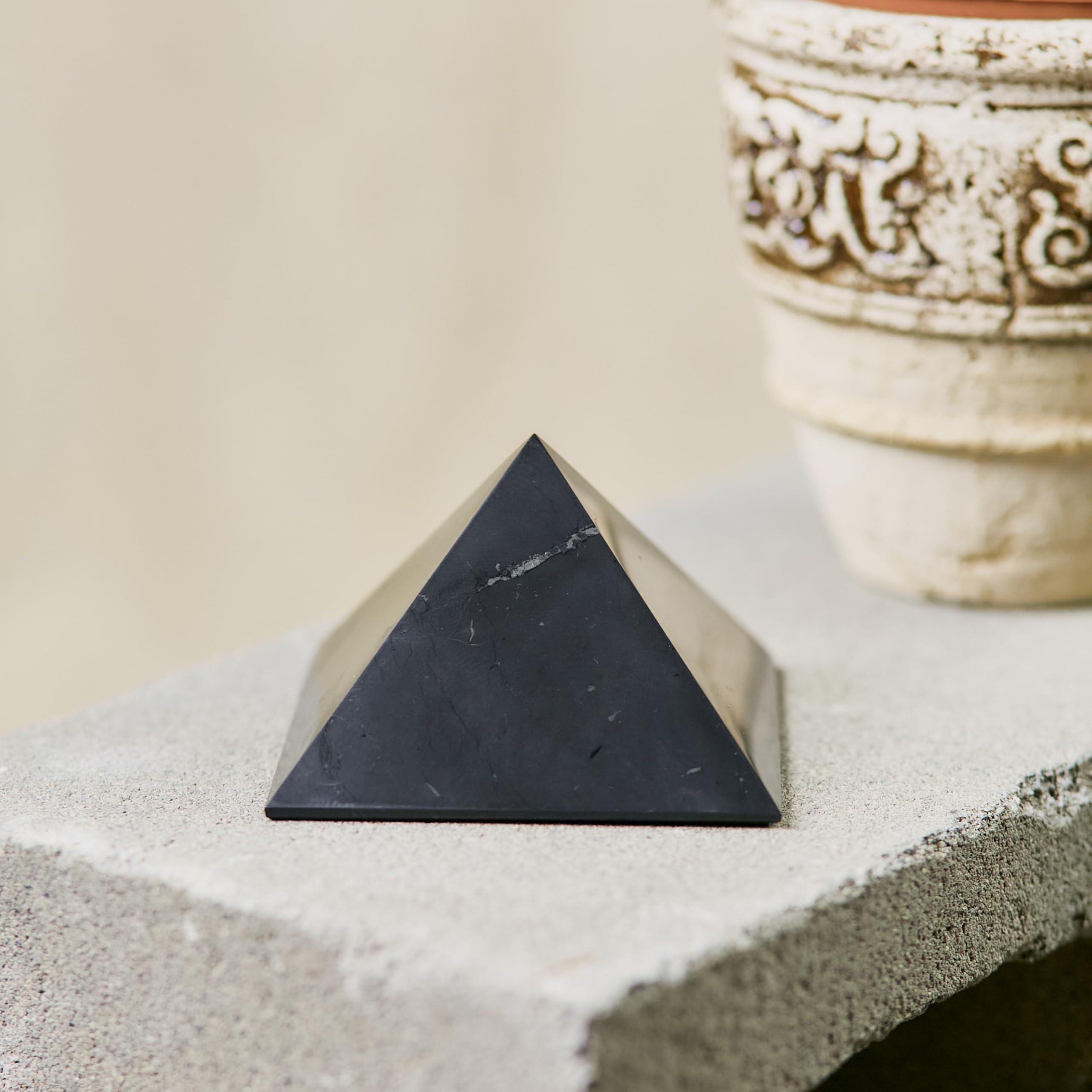 Karelian Heritage shungite pyramid radiates subtle energy in a room corner.