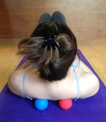 Kieba blue lacrosse ball on lower back to ease tightness