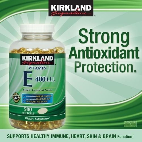 Pouring Kirkland Vitamin E softgels suggests easy daily use for heart and immune health.