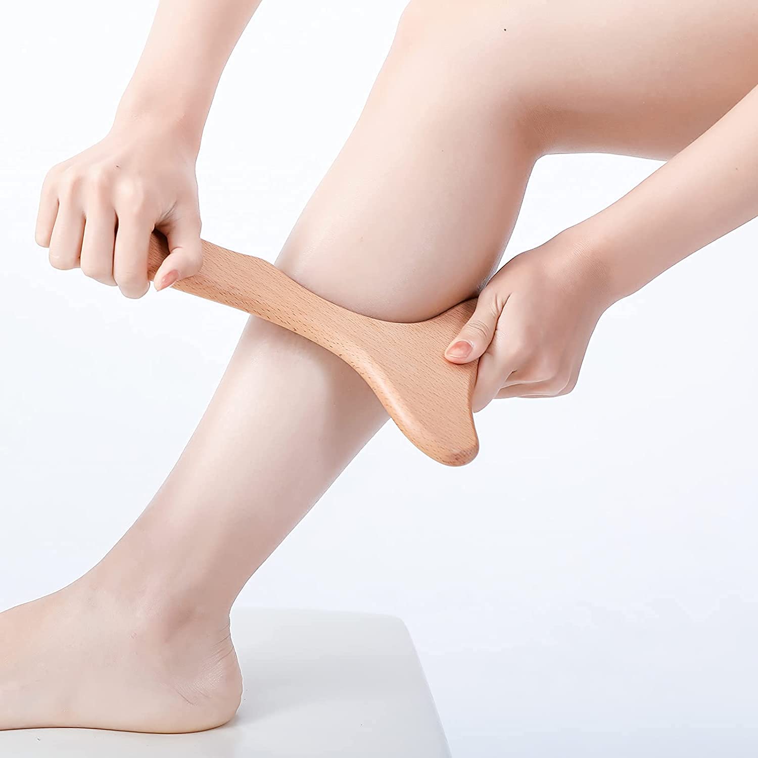 Komogir wood massager in use on arm demonstrates easy control and potential relief.